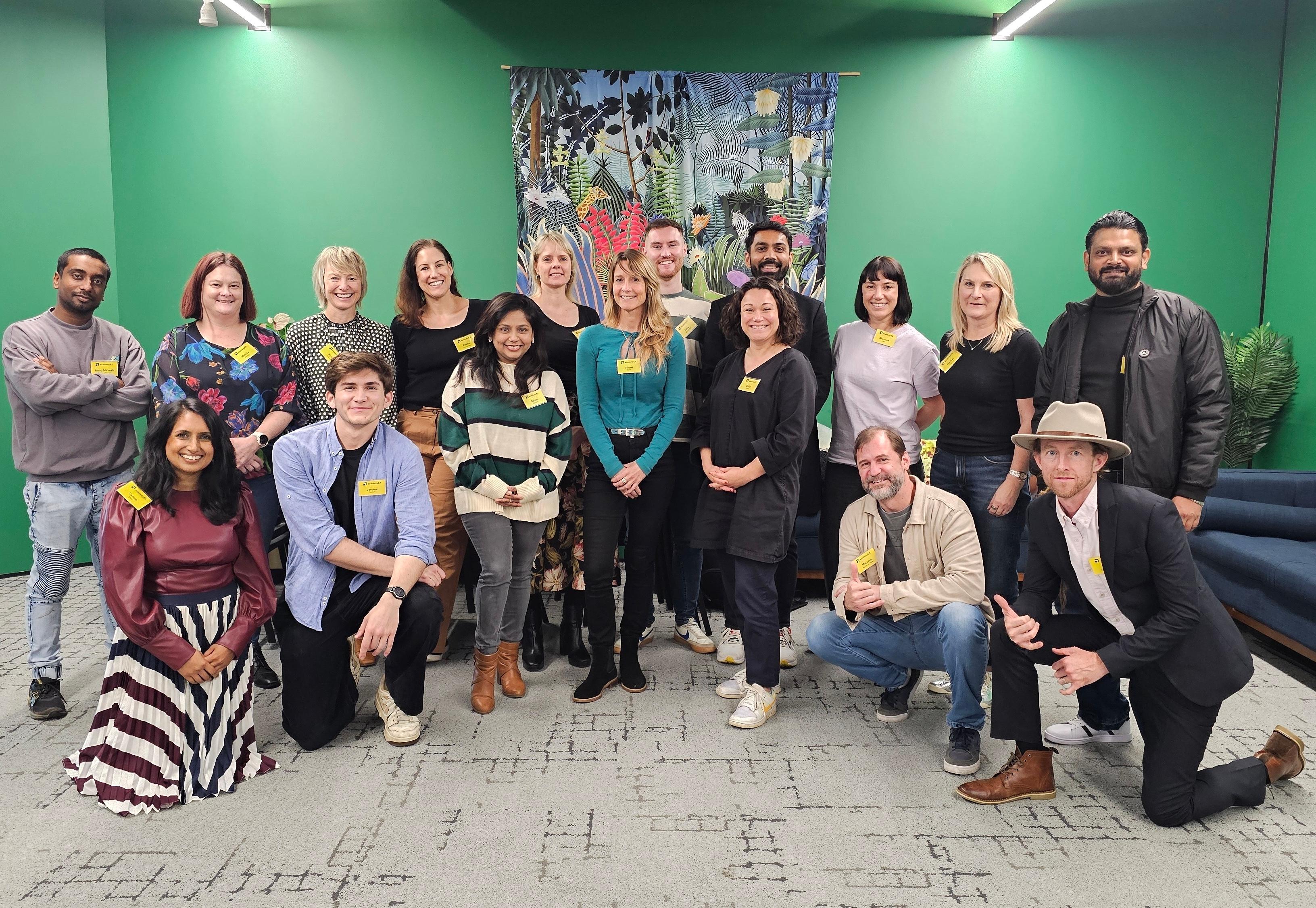 A group of people standing in one line and smiling.